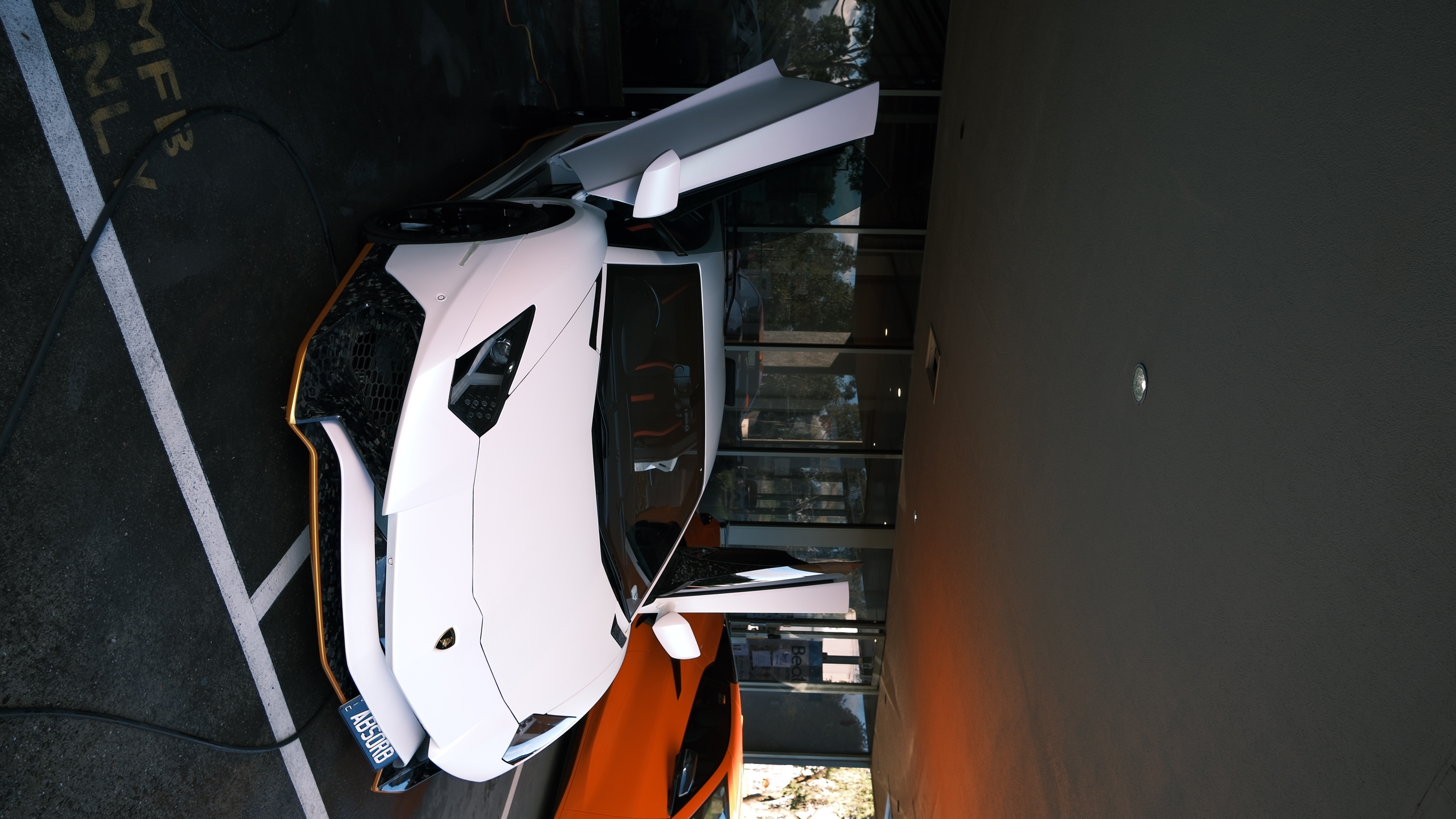 White Lamborghini Aventador with scissor doors open